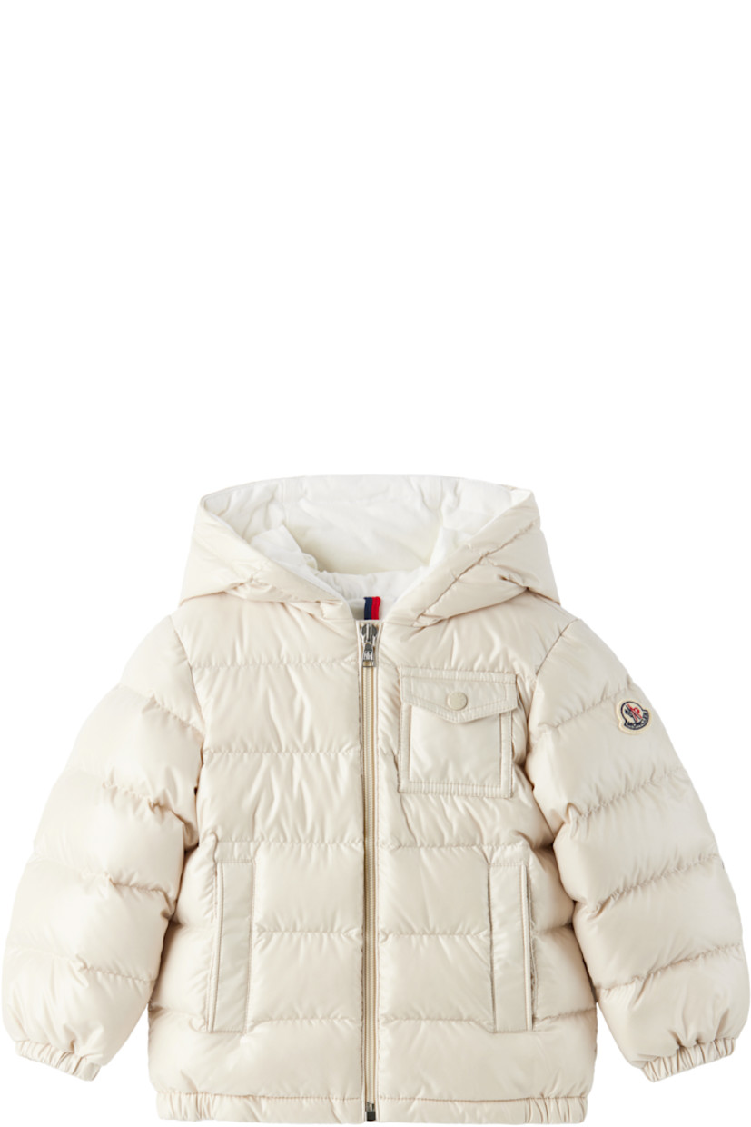 Down-filled quilted satin jacket. 

· DIST-certified down
· Zip closure
· Flap pocket at chest
· Welt pockets at waist 
· Elasticized hem and cuffs
· Tricolor felted logo patch at sleeve
· Full jersey lining
· Machine-wash

Supplier color: Light beige

Moncler Enfant Size: child's height
1-3M: 21.7" / 55 cm
3-6M: 24.4" / 62 cm
6-9M: 26.7" / 68 cm
9-12M: 29.9" / 76 cm
12-18M: 31.4" / 80 cm
18-24M: 33.9" / 86 cm
2Y: 36.2" / 92 cm
3Y: 39.4" / 100 cm

Fill 1: 90% goose down, 10% goose feather.