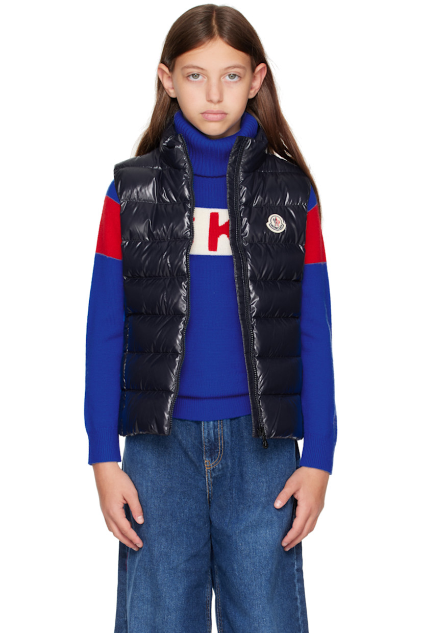 Down-filled and quilted nylon laqué vest.

· DIST-certified down
· Stand collar
· Zip closure
· Felted logo patch at chest
· Zip pockets at front
· Fully lined

Supplier color: Blue navy

Model measures 55" / 139.7 cm tall and wears size 12Y.

Moncler Enfant Size: child's height
8Y: 51.2" / 130 cm 
10Y: 55.2" / 140 cm 
12Y: 59.8" / 152 cm 
14Y: 64.6" / 164 cm