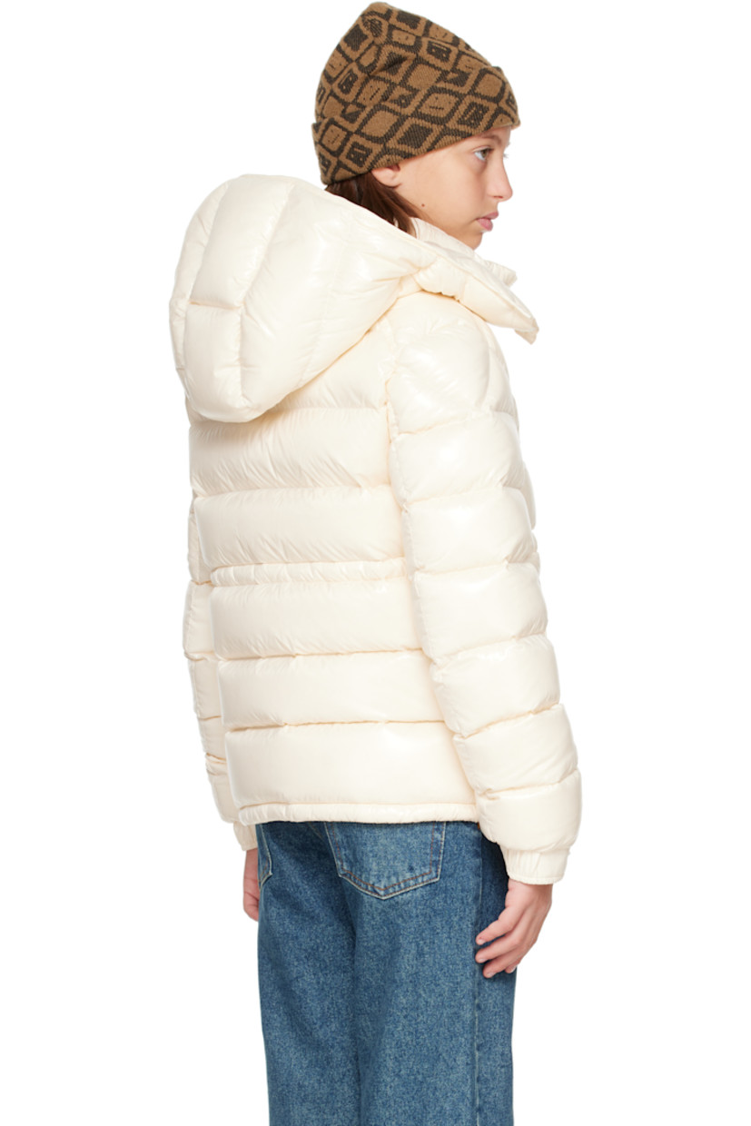 Down-filled and quilted nylon laqué jacket.

· DIST-certified down
· Detachable hood at stand collar
· Zip closure
· Zip pockets at front
· Elasticized hem
· Flap pocket and felted logo patch at sleeve
· Adjustable press-stud fastening at elasticized cuffs
· Bungee-style drawstring at interior waist
· Fully lined

Supplier color: White

Model measures 55" / 139.7 cm tall and wears size 12Y.

Moncler Enfant Size: child's height
8Y: 51.2" / 130 cm 
10Y: 55.2" / 140 cm 
12Y: 59.8" / 152 cm 
14Y: 64.6" / 164 cm