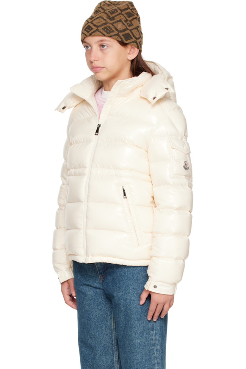Down-filled and quilted nylon laqué jacket.

· DIST-certified down
· Detachable hood at stand collar
· Zip closure
· Zip pockets at front
· Elasticized hem
· Flap pocket and felted logo patch at sleeve
· Adjustable press-stud fastening at elasticized cuffs
· Bungee-style drawstring at interior waist
· Fully lined

Supplier color: White

Model measures 55" / 139.7 cm tall and wears size 12Y.

Moncler Enfant Size: child's height
8Y: 51.2" / 130 cm 
10Y: 55.2" / 140 cm 
12Y: 59.8" / 152 cm 
14Y: 64.6" / 164 cm