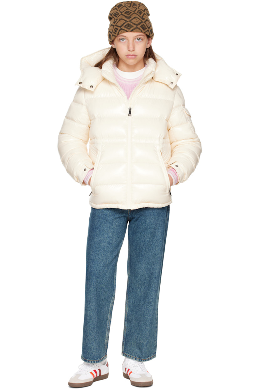 Down-filled and quilted nylon laqué jacket.

· DIST-certified down
· Detachable hood at stand collar
· Zip closure
· Zip pockets at front
· Elasticized hem
· Flap pocket and felted logo patch at sleeve
· Adjustable press-stud fastening at elasticized cuffs
· Bungee-style drawstring at interior waist
· Fully lined

Supplier color: White

Model measures 55" / 139.7 cm tall and wears size 12Y.

Moncler Enfant Size: child's height
8Y: 51.2" / 130 cm 
10Y: 55.2" / 140 cm 
12Y: 59.8" / 152 cm 
14Y: 64.6" / 164 cm
