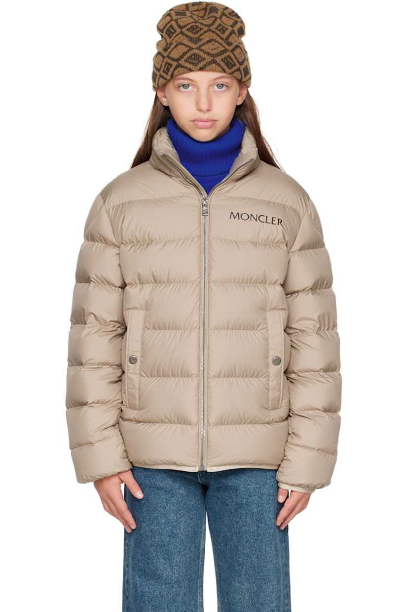 Down-filled and quilted recycled polyester satin jacket.

· DIST-certified down
· Stowaway hood at stand collar
· Zip closure
· Logo printed at chest
· Welt pockets  at front
· Elasticized hem and cuffs
· Felted logo patch at sleeve
· Fully lined

Supplier color: Light beige

Model measures 55" / 139.7 cm tall and wears size 12Y.

Moncler Enfant Size: child's height
8Y: 51.2" / 130 cm 
10Y: 55.2" / 140 cm 
12Y: 59.8" / 152 cm 
14Y: 64.6" / 164 cm