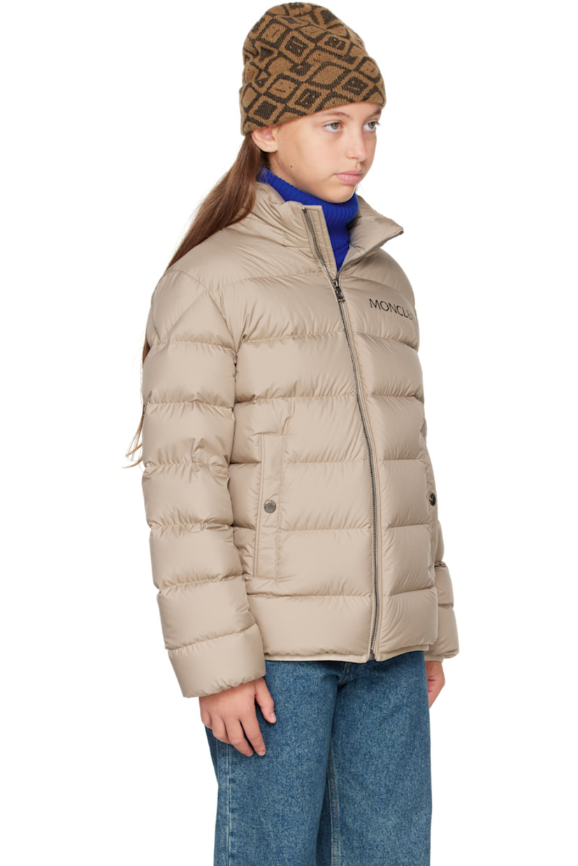 Down-filled and quilted recycled polyester satin jacket.

· DIST-certified down
· Stowaway hood at stand collar
· Zip closure
· Logo printed at chest
· Welt pockets  at front
· Elasticized hem and cuffs
· Felted logo patch at sleeve
· Fully lined

Supplier color: Light beige

Model measures 55" / 139.7 cm tall and wears size 12Y.

Moncler Enfant Size: child's height
8Y: 51.2" / 130 cm 
10Y: 55.2" / 140 cm 
12Y: 59.8" / 152 cm 
14Y: 64.6" / 164 cm
