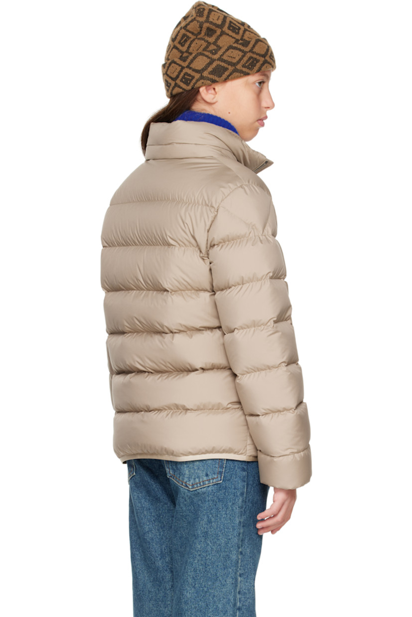 Down-filled and quilted recycled polyester satin jacket.

· DIST-certified down
· Stowaway hood at stand collar
· Zip closure
· Logo printed at chest
· Welt pockets  at front
· Elasticized hem and cuffs
· Felted logo patch at sleeve
· Fully lined

Supplier color: Light beige

Model measures 55" / 139.7 cm tall and wears size 12Y.

Moncler Enfant Size: child's height
8Y: 51.2" / 130 cm 
10Y: 55.2" / 140 cm 
12Y: 59.8" / 152 cm 
14Y: 64.6" / 164 cm