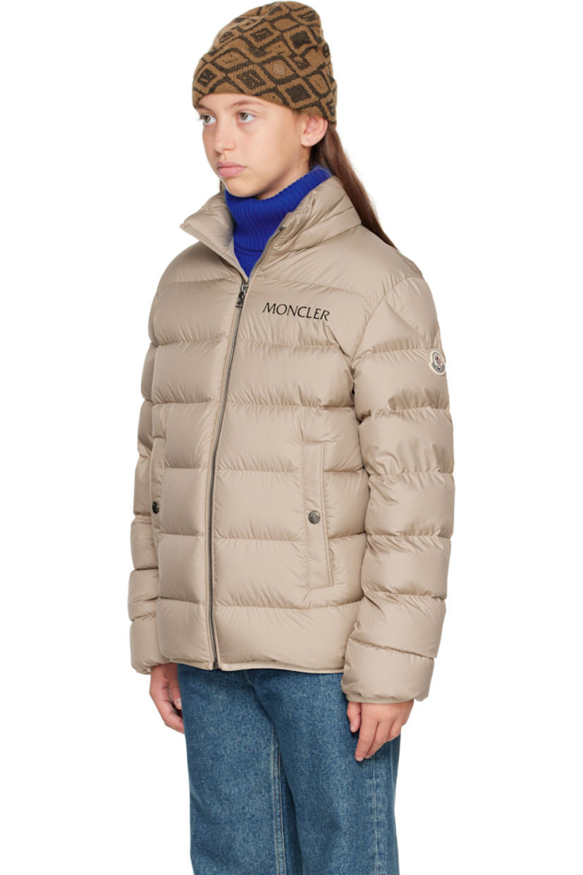 Down-filled and quilted recycled polyester satin jacket.

· DIST-certified down
· Stowaway hood at stand collar
· Zip closure
· Logo printed at chest
· Welt pockets  at front
· Elasticized hem and cuffs
· Felted logo patch at sleeve
· Fully lined

Supplier color: Light beige

Model measures 55" / 139.7 cm tall and wears size 12Y.

Moncler Enfant Size: child's height
8Y: 51.2" / 130 cm 
10Y: 55.2" / 140 cm 
12Y: 59.8" / 152 cm 
14Y: 64.6" / 164 cm