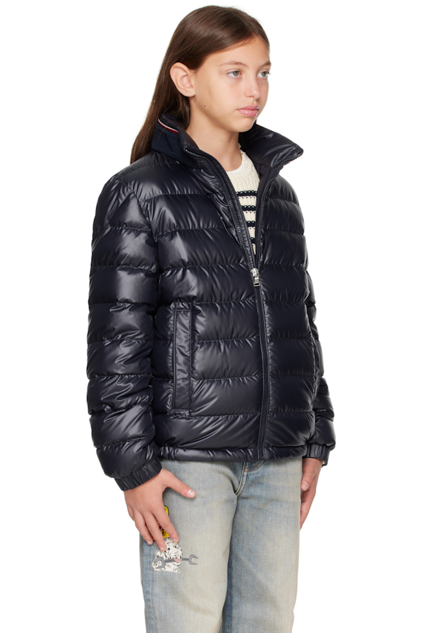 Down-filled and quilted recycled polyester satin jacket. 

· DIST-certified down
· Rib-knit stand collar
· Zip closure
· Welt pockets at front
· Partially elasticized hem
· Felted logo patch at sleeve
· Elasticized cuffs
· Fully lined

Supplier color: Blue navy

Model measures 55" / 139.7 cm tall and wears size 12Y.

Moncler Enfant Size: child's height
8Y: 51.2" / 130 cm 
10Y: 55.2" / 140 cm 
12Y: 59.8" / 152 cm 
14Y: 64.6" / 164 cm