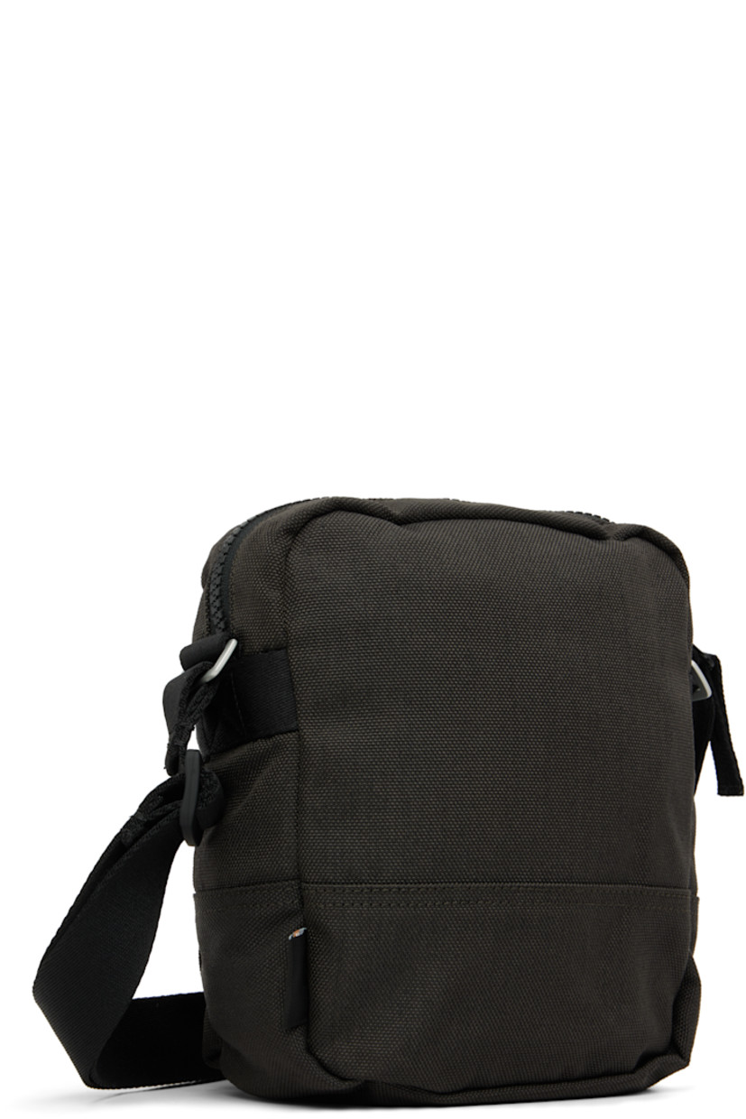 CORDURA® 1500 nylon canvas pouch.

· Water-resistant
· Adjustable crossbody strap
· Embroidered logo patch at face
· Zip compartment at face
· Logo flag at side
· Zip closure
· Zip pocket at interior
· Polyurethane-coated ripstop lining
· H7.5" x W6.5" x D2.25"

Supplier color: Lead grey