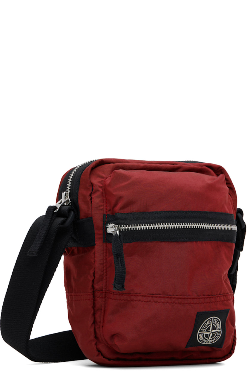 Coated ECONYL® nylon taffeta pouch.

· Adjustable crossbody strap
· Zip pocket and logo patch at face
· Flap pocket at back face
· Zip closure
· Patch pocket at interior
· Ripstop lining
· H8" x W7" x D2.5"

Supplier color: Scarlet