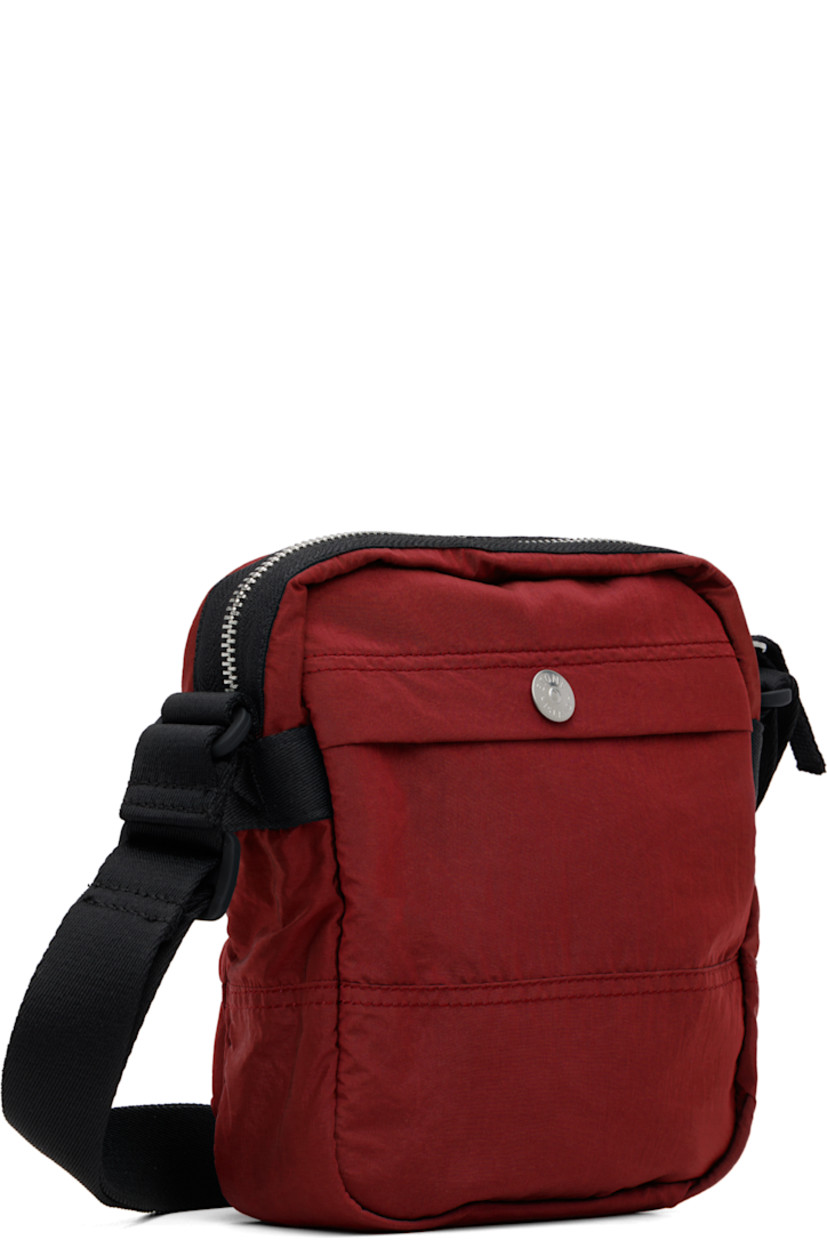 Coated ECONYL® nylon taffeta pouch.

· Adjustable crossbody strap
· Zip pocket and logo patch at face
· Flap pocket at back face
· Zip closure
· Patch pocket at interior
· Ripstop lining
· H8" x W7" x D2.5"

Supplier color: Scarlet