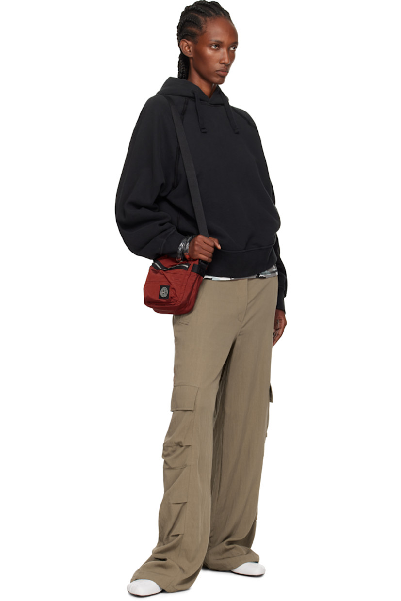 Coated ECONYL® nylon taffeta pouch.

· Adjustable crossbody strap
· Zip pocket and logo patch at face
· Flap pocket at back face
· Zip closure
· Patch pocket at interior
· Ripstop lining
· H8" x W7" x D2.5"

Supplier color: Scarlet