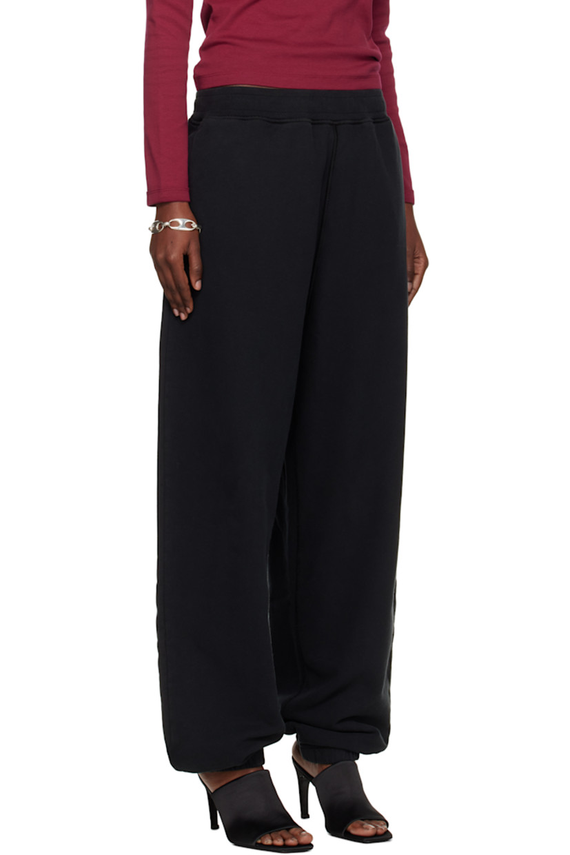 Loose-fit garment-dyed organic cotton fleece lounge pants.

· Overlock stitching throughout
· Concealed drawstring at elasticized waistband
· Three-pocket styling
· Elasticized cuffs
· Detachable felted logo patch at outseam
· Logo-engraved silver-tone hardware

Supplier color: Black