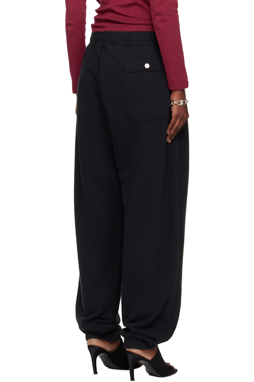 Loose-fit garment-dyed organic cotton fleece lounge pants.

· Overlock stitching throughout
· Concealed drawstring at elasticized waistband
· Three-pocket styling
· Elasticized cuffs
· Detachable felted logo patch at outseam
· Logo-engraved silver-tone hardware

Supplier color: Black