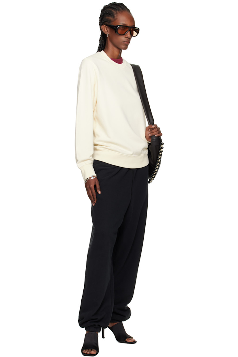 Loose-fit garment-dyed organic cotton fleece lounge pants.

· Overlock stitching throughout
· Concealed drawstring at elasticized waistband
· Three-pocket styling
· Elasticized cuffs
· Detachable felted logo patch at outseam
· Logo-engraved silver-tone hardware

Supplier color: Black