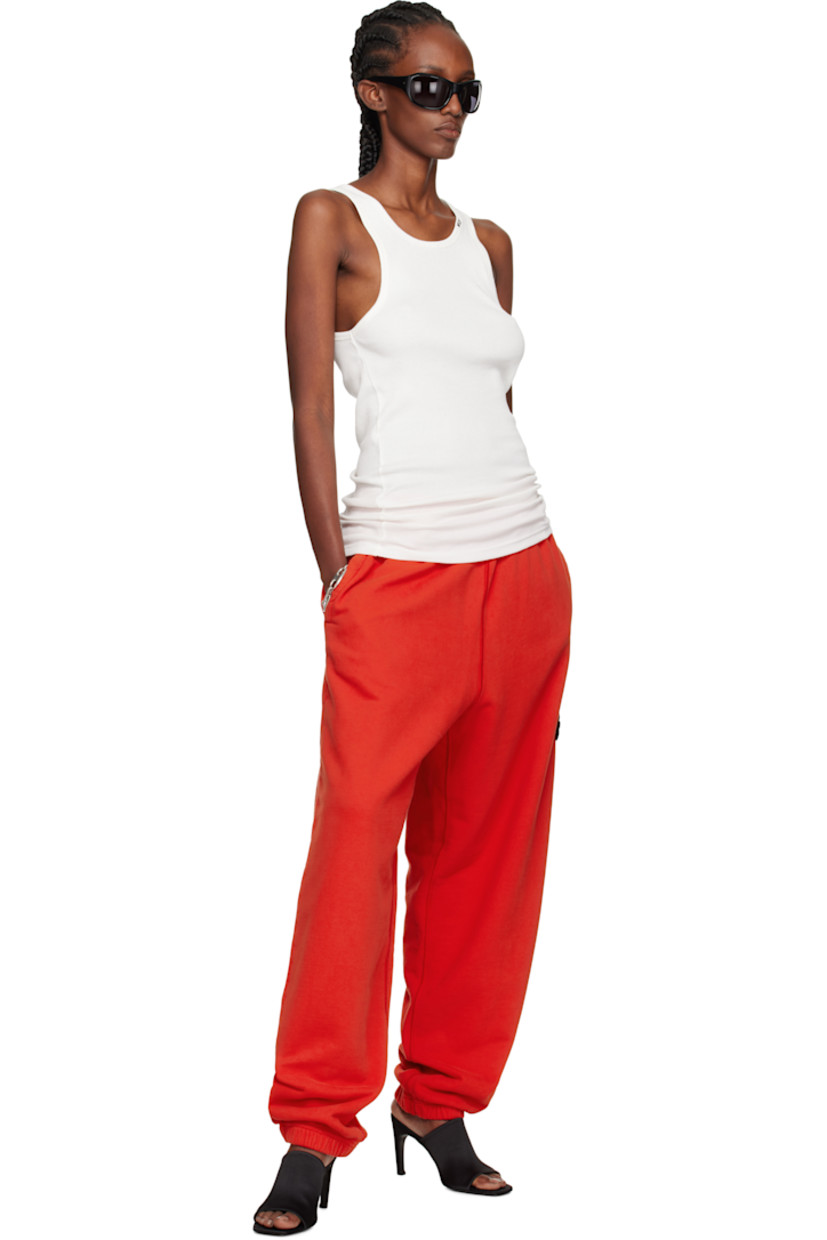 Loose-fit garment-dyed organic cotton fleece lounge pants.

· Overlock stitching throughout
· Concealed drawstring at elasticized waistband
· Three-pocket styling
· Elasticized cuffs
· Detachable felted logo patch at outseam
· Logo-engraved silver-tone hardware

Supplier color: Scarlatto
