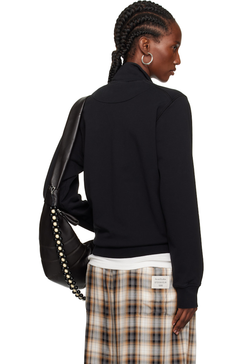 Garment-dyed organic cotton French terry jacket.

· Overlock stitching throughout
· Stand collar
· Zip closure
· Patch pockets
· Rib-knit hem and cuffs
· Detachable felted logo patch at sleeve

Supplier color: Black