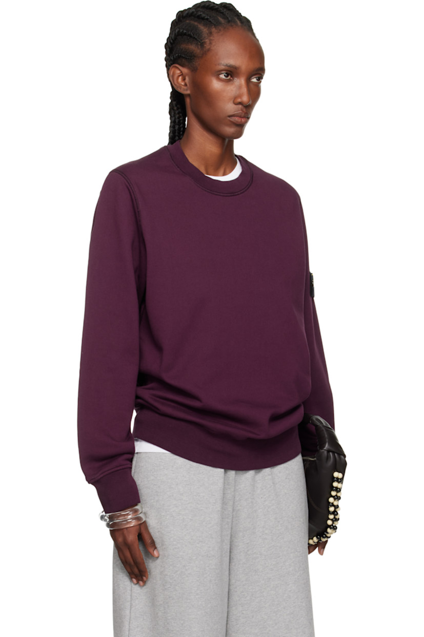 Garment-dyed organic cotton fleece sweatshirt. 

· Overlock stitching throughout
· Rib-knit crewneck, hem, and cuffs
· Detachable felted logo patch at sleeve

Supplier color: Amaranth
