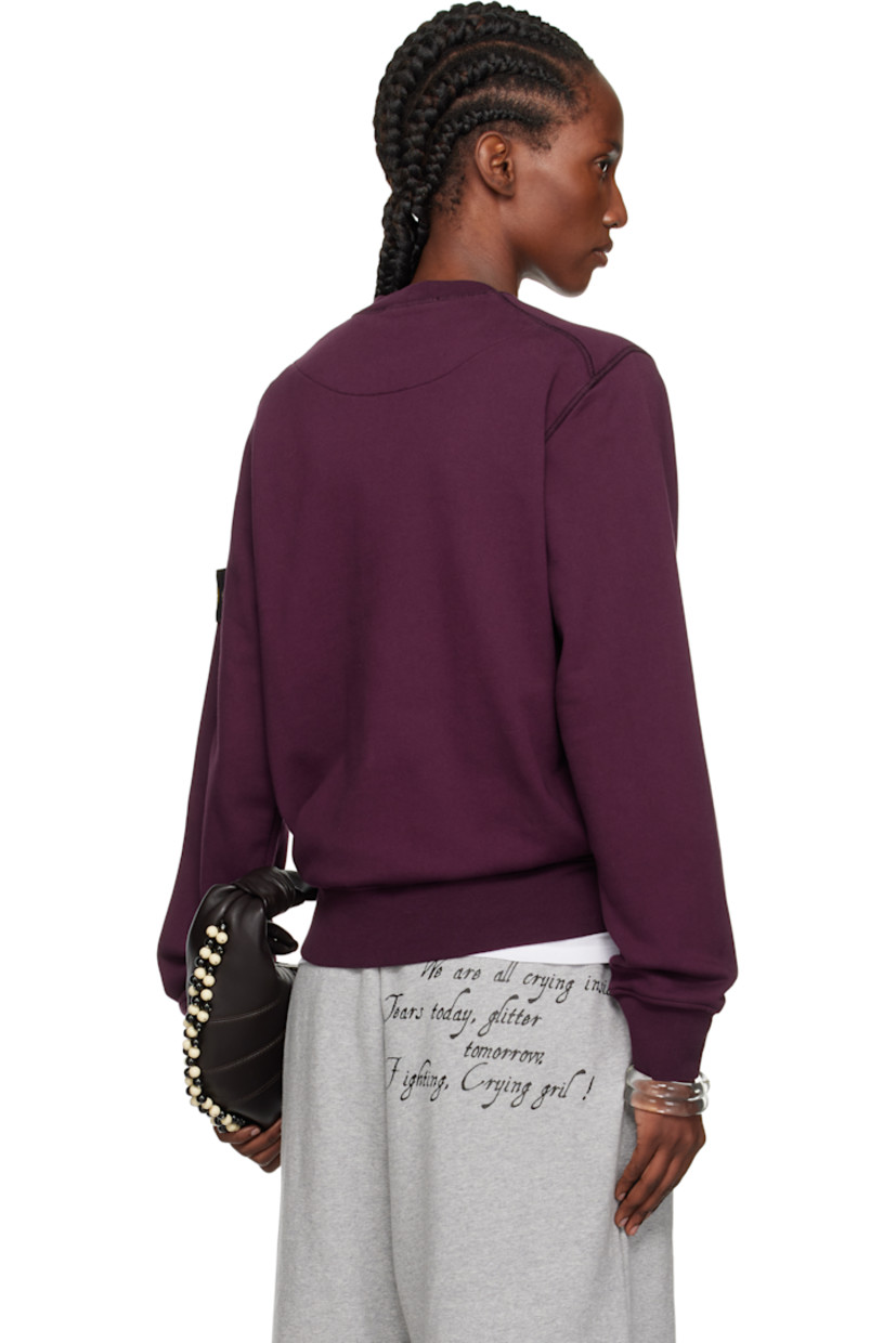 Garment-dyed organic cotton fleece sweatshirt. 

· Overlock stitching throughout
· Rib-knit crewneck, hem, and cuffs
· Detachable felted logo patch at sleeve

Supplier color: Amaranth