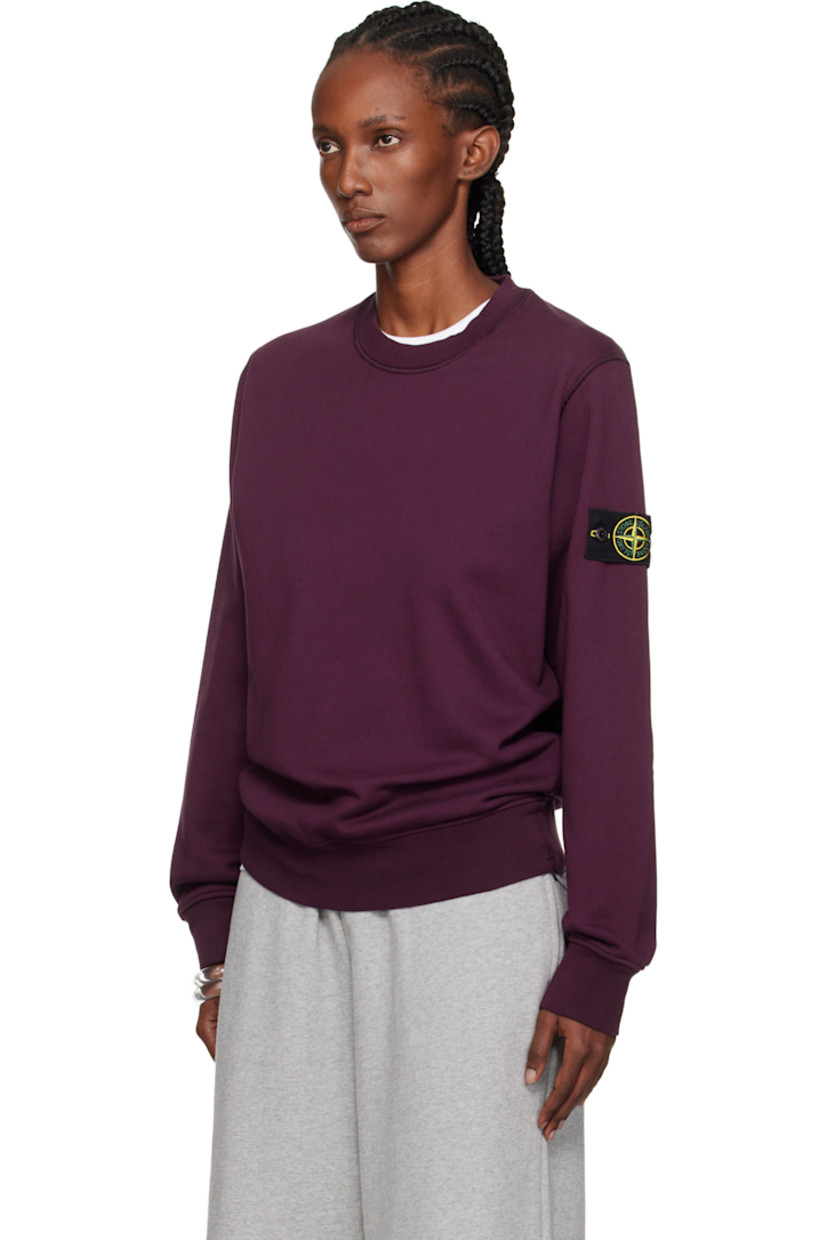 Garment-dyed organic cotton fleece sweatshirt. 

· Overlock stitching throughout
· Rib-knit crewneck, hem, and cuffs
· Detachable felted logo patch at sleeve

Supplier color: Amaranth