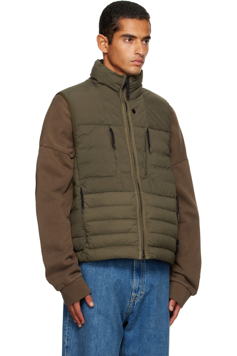 Down-filled and quilted stretch nylon taffeta vest.

· RDS-certified down
· Garment-dyed
· Stand collar
· Two-way zip closure
· Zip pockets at chest and waist
· Bungee-style drawstring at hem
· Detachable felted logo patch at side seam
· Elasticized armscyes
· Fully lined

Supplier color: Military green

Fill: 90% duck down, 10% duck feathers.