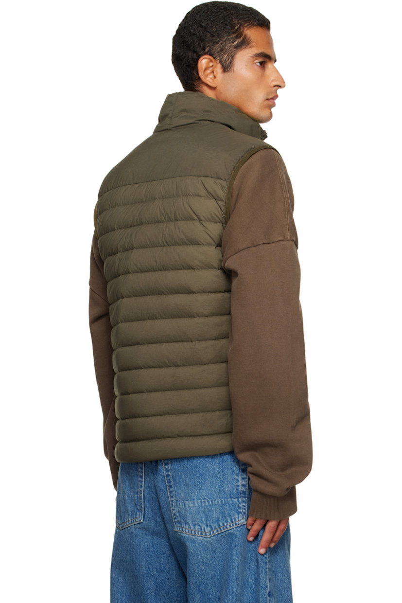 Down-filled and quilted stretch nylon taffeta vest.

· RDS-certified down
· Garment-dyed
· Stand collar
· Two-way zip closure
· Zip pockets at chest and waist
· Bungee-style drawstring at hem
· Detachable felted logo patch at side seam
· Elasticized armscyes
· Fully lined

Supplier color: Military green

Fill: 90% duck down, 10% duck feathers.