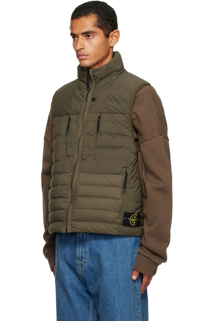 Down-filled and quilted stretch nylon taffeta vest.

· RDS-certified down
· Garment-dyed
· Stand collar
· Two-way zip closure
· Zip pockets at chest and waist
· Bungee-style drawstring at hem
· Detachable felted logo patch at side seam
· Elasticized armscyes
· Fully lined

Supplier color: Military green

Fill: 90% duck down, 10% duck feathers.