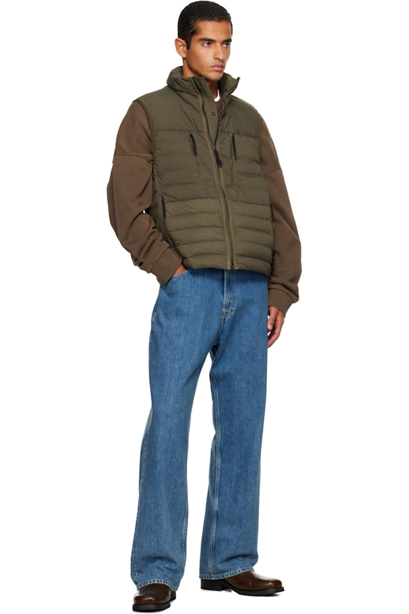 Down-filled and quilted stretch nylon taffeta vest.

· RDS-certified down
· Garment-dyed
· Stand collar
· Two-way zip closure
· Zip pockets at chest and waist
· Bungee-style drawstring at hem
· Detachable felted logo patch at side seam
· Elasticized armscyes
· Fully lined

Supplier color: Military green

Fill: 90% duck down, 10% duck feathers.