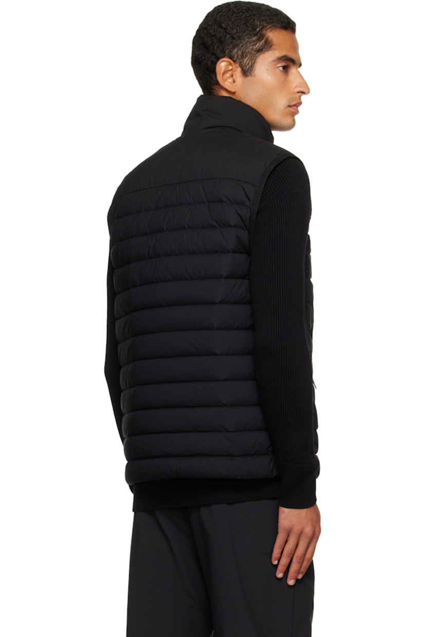 Down-filled and quilted stretch nylon taffeta vest.

· RDS-certified down
· Garment-dyed
· Stand collar
· Two-way zip closure
· Zip pockets at chest and waist
· Bungee-style drawstring at hem
· Detachable felted logo patch at side seam
· Elasticized armscyes
· Fully lined

Supplier color: Black

Fill: 90% duck down, 10% duck feather.