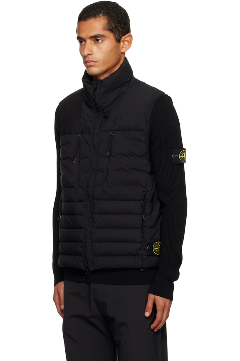 Down-filled and quilted stretch nylon taffeta vest.

· RDS-certified down
· Garment-dyed
· Stand collar
· Two-way zip closure
· Zip pockets at chest and waist
· Bungee-style drawstring at hem
· Detachable felted logo patch at side seam
· Elasticized armscyes
· Fully lined

Supplier color: Black

Fill: 90% duck down, 10% duck feather.