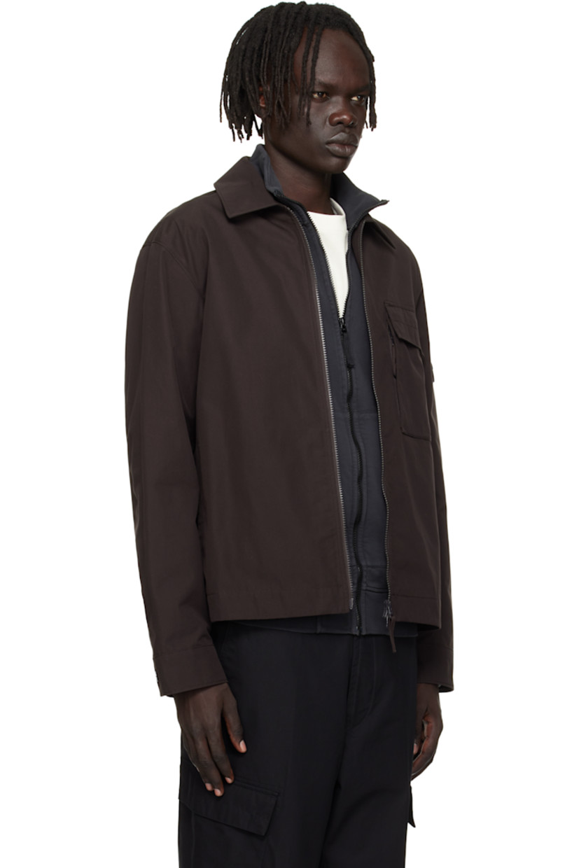 Organic cotton canvas overshirt. 

· Spread collar 
· Two-way zip closure
· Flap pocket at chest
· Seam pockets at waist
· Detachable felted logo patch at sleeve
· Press-stud barrel cuffs
· Adjustable press-stud tabs at back hem 

Part of the Ghost collection.

Supplier color: Dark brown