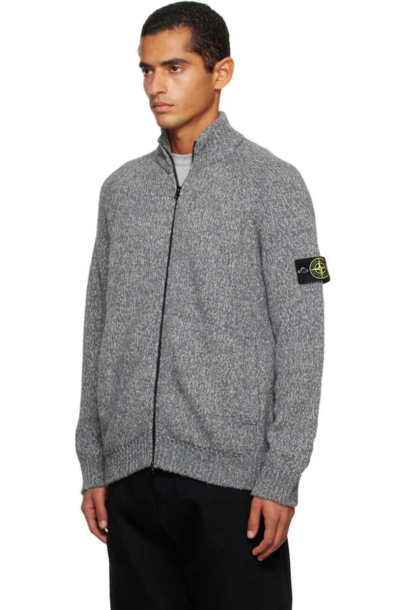 Knit virgin wool-blend cardigan. 

· Rib-knit stand collar, hem, and cuffs
· Two-way zip closure
· Patch pockets at waist
· Raglan sleeves
· Detachable felted logo patch at sleeve

Supplier color: Cement melange
