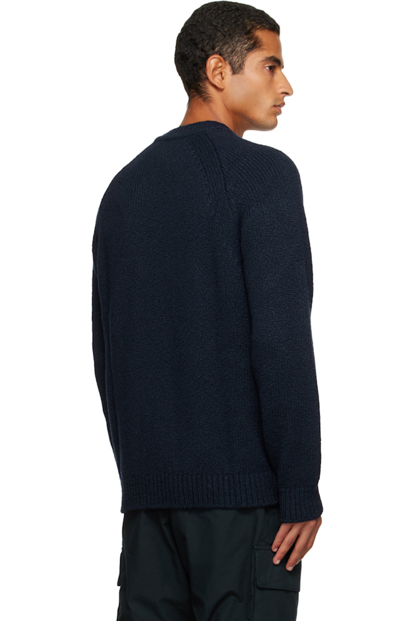 3-gauge knit virgin wool-blend sweater. 

· Rib-knit crewneck, hem, and cuffs
· Raglan sleeves
· Detachable felted logo patch at sleeve

Supplier color: Navy blue