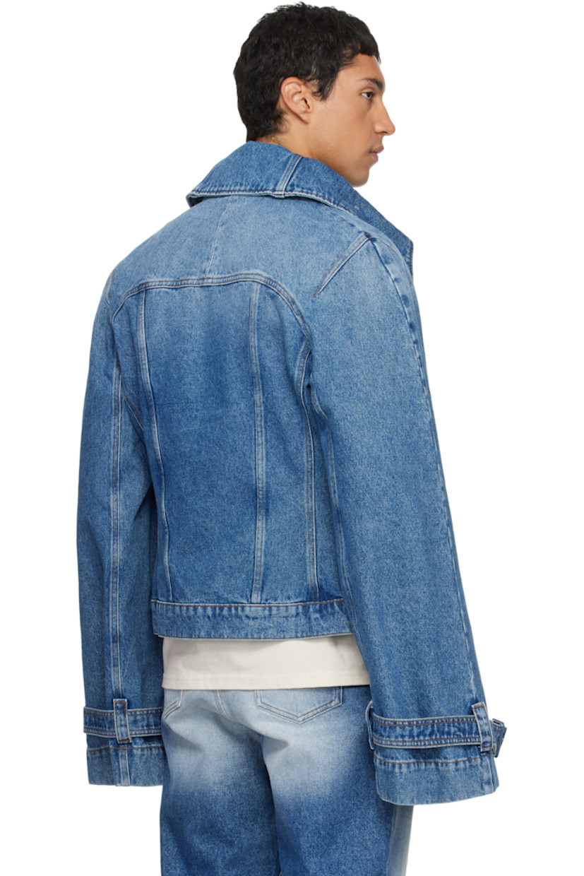 Non-stretch denim jacket.

· Fading throughout
· Button fastenings at funnel neck
· Button closure
· Flap and welt pockets at front
· Yoke sleeves
· Pin-buckle strap at cuffs
· Contrast stitching in tan

Supplier color: Blue