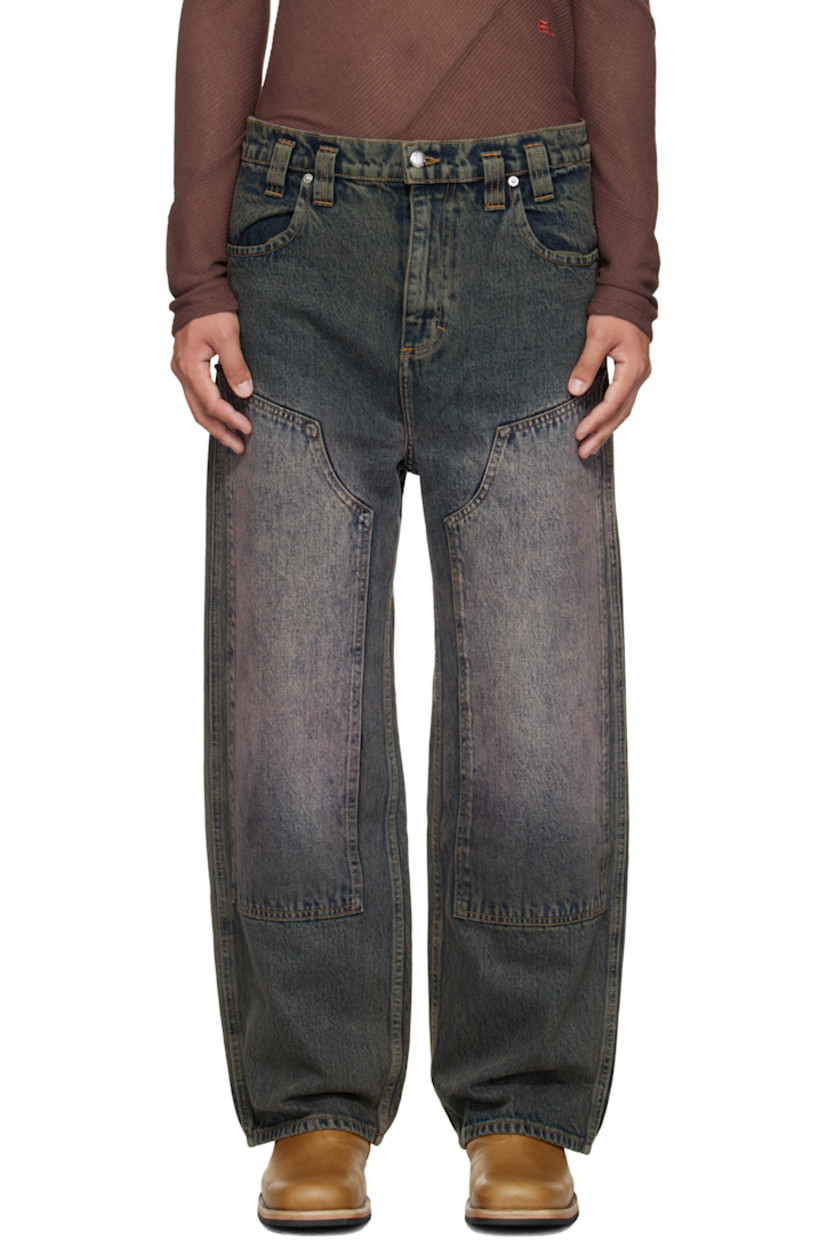 Overdyed 14 oz non-stretch denim jeans. 

· Fading throughout 
· Wide-leg 
· Belt loops
· Four-pocket styling
· Zip fly 
· Reinforced panel at knees
· Hammer loop at back pocket 
· Contrast stitching in tan 

Supplier color: Moon rock