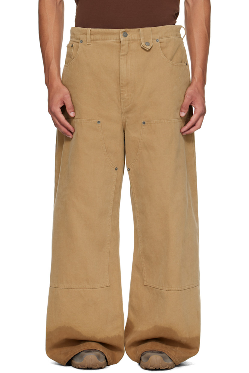 Cotton canvas jeans. 

· Wide-leg 
· Belt loops
· Press-stud tab at waistband 
· Five-pocket styling
· Zip fly 
· Rivets and reinforced panel at knees 
· Discoloration at cuffs
· Logo patch at back waistband

Supplier color: Beige