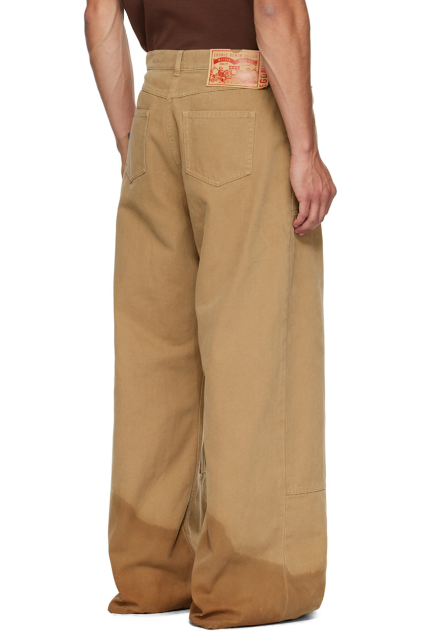 Cotton canvas jeans. 

· Wide-leg 
· Belt loops
· Press-stud tab at waistband 
· Five-pocket styling
· Zip fly 
· Rivets and reinforced panel at knees 
· Discoloration at cuffs
· Logo patch at back waistband

Supplier color: Beige