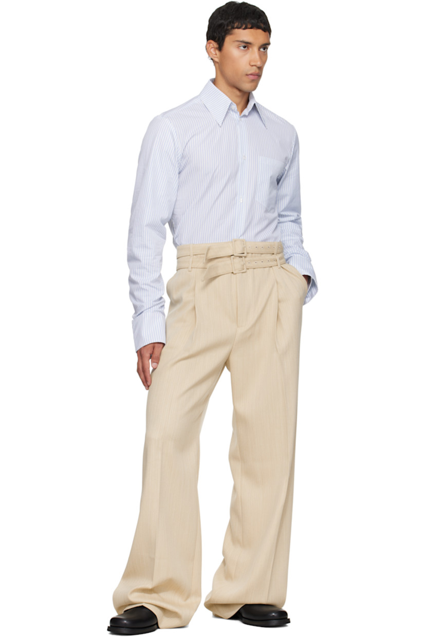 Virgin wool tweed trousers.

· High-rise 
· Layered belt loops and detachable pin-buckle belt 
· Four-pocket styling
· Zip fly 
· Pleats at front 
· Creased legs

Supplier color: Beige