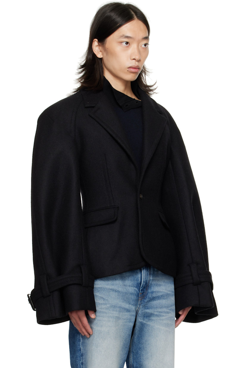 Wool-blend melton blazer.

· Notched lapel
· Button closure
· Flap pockets at front
· Raglan sleeves
· Pin-buckle strap at cuffs
· Central vent at back hem
· Welt pockets at interior
· Full satin lining

Supplier color: Black