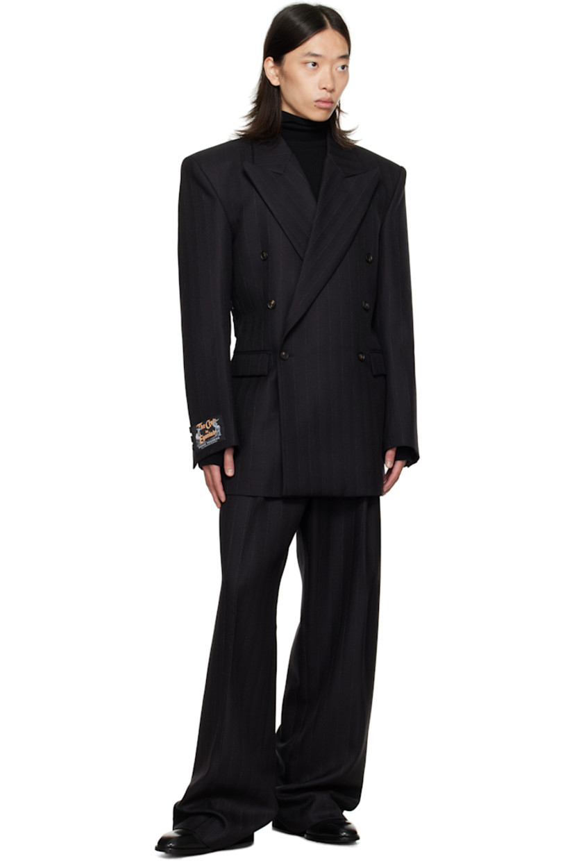 Virgin wool herringbone blazer.

· Peaked lapel
· Double-breasted button closure
· Flap pockets at front
· Padded shoulders
· Logo patch at cuff
· Surgeon's cuffs
· Button strap at back
· Central vent at back hem
· Welt pockets at interior
· Full satin lining

Supplier color: Black