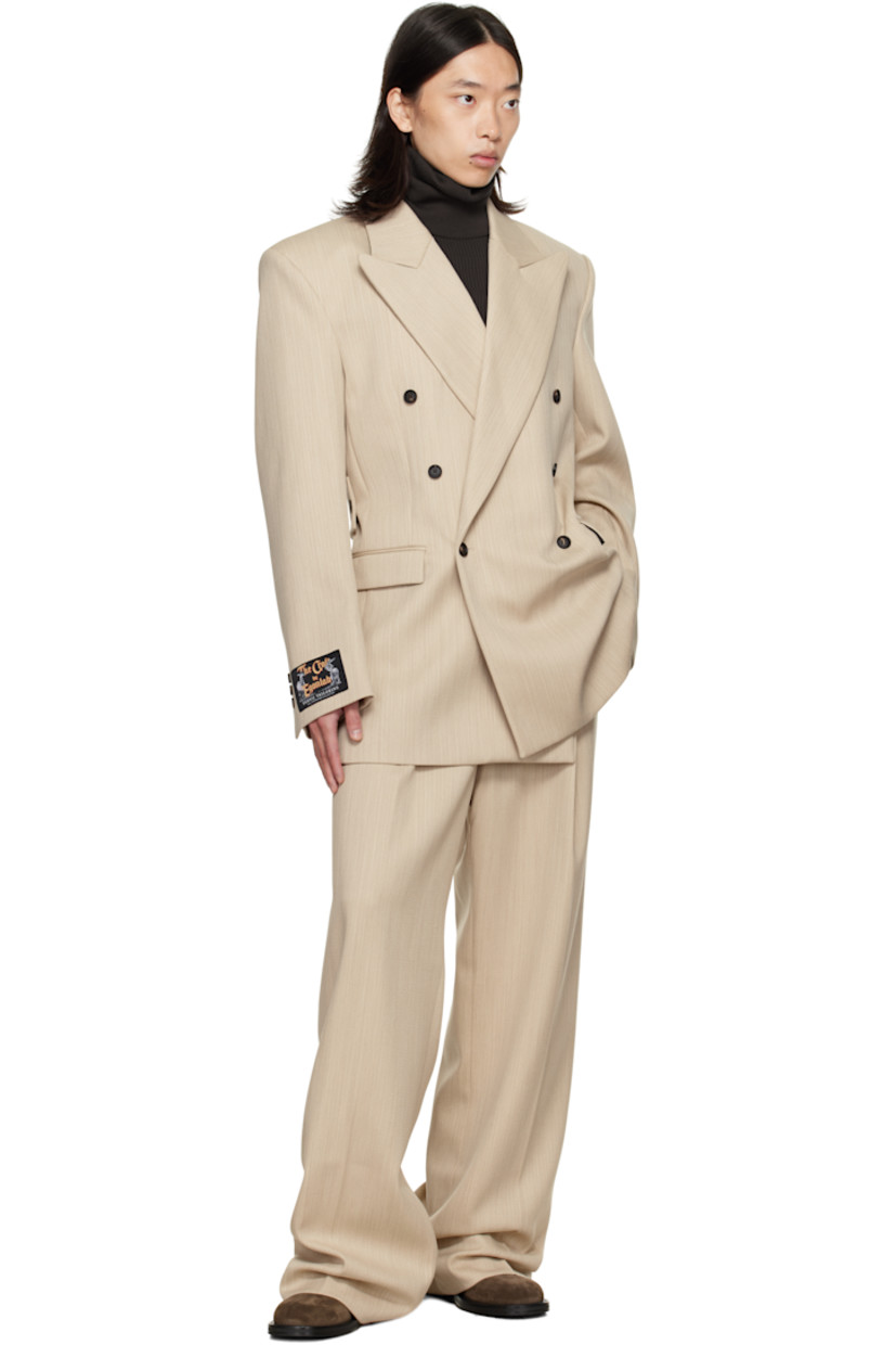 Virgin wool canvas blazer.

· Peaked lapel
· Double-breasted button closure
· Flap pockets at front
· Padded shoulders
· Logo patch at cuff
· Surgeon's cuffs
· Button strap at back
· Central vent at back hem
· Welt pockets at interior
· Full satin lining

Supplier color: Beige