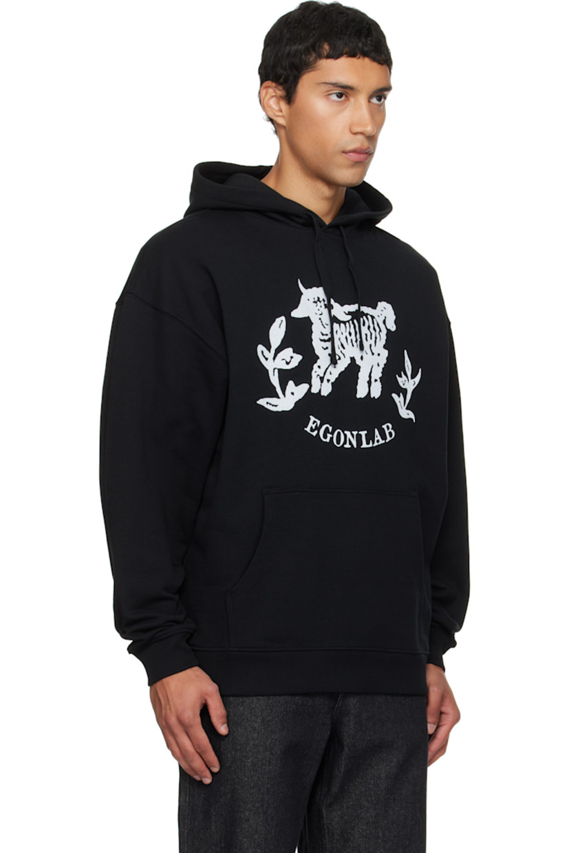 Organic cotton fleece hoodie.

· Drawstring at hood
· Graphic and logo printed at chest
· Kangaroo pocket
· Rib-knit hem and cuffs
· Dropped shoulders
· Text and logo graphic printed at back

Supplier color: Black