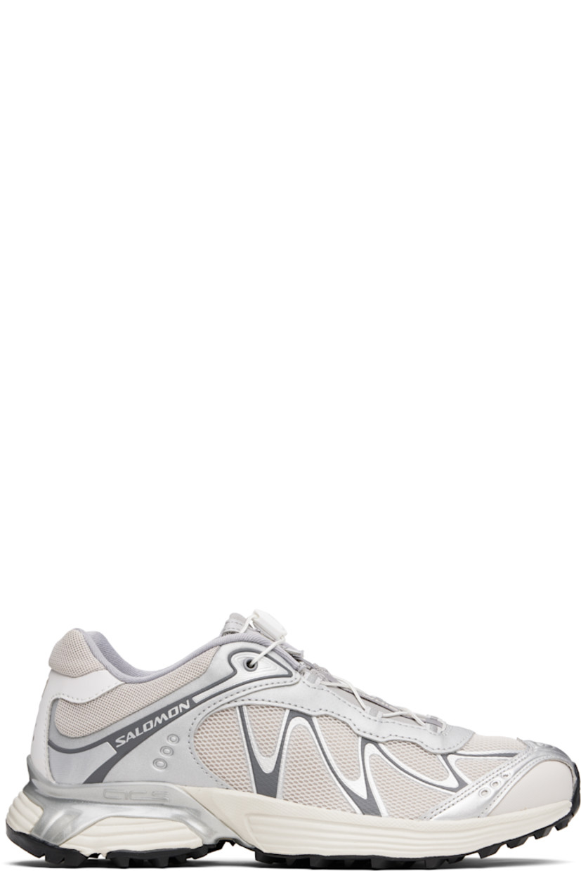 Low-top mesh and faux-nubuck sneakers in silver tone and beige.

· Reflective trim throughout
· Logo embossed at toe
· Quicklace™ closure
· Logo patch at padded tongue
· Padded collar
· sensiFIT™ panel at sides
· Logo printed at outer side and heel tab
· Molded OrthoLite® insole
· Mesh lining
· Agile Chassis™ System at EnergyCell midsole
· Treaded Mud Contagrip® rubber sole

Supplier color: Ftw silver/Lunar rock/Silver cloud