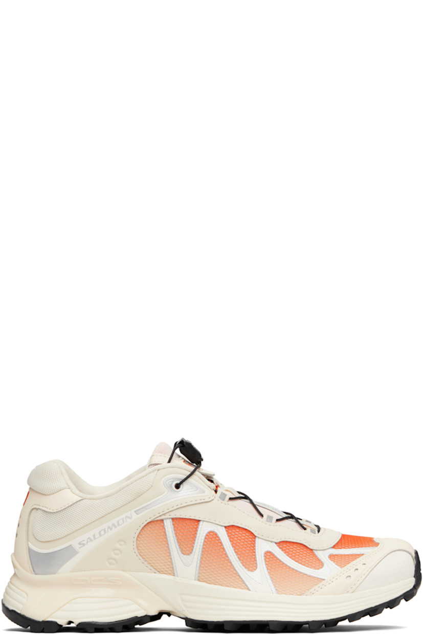 Low-top mesh and faux-nubuck sneakers in off-white and orange.

· Reflective trim and gradient throughout
· Logo embossed at toe
· Quicklace™ closure
· Logo patch at padded tongue
· Padded collar
· sensiFIT™ panel at sides
· Logo printed at outer side and heel tab
· Molded OrthoLite® insole
· Mesh lining
· Agile Chassis™ System at EnergyCell midsole
· Treaded Mud Contagrip® rubber sole

Supplier color: Shortbread/Red orange/Ftw silver