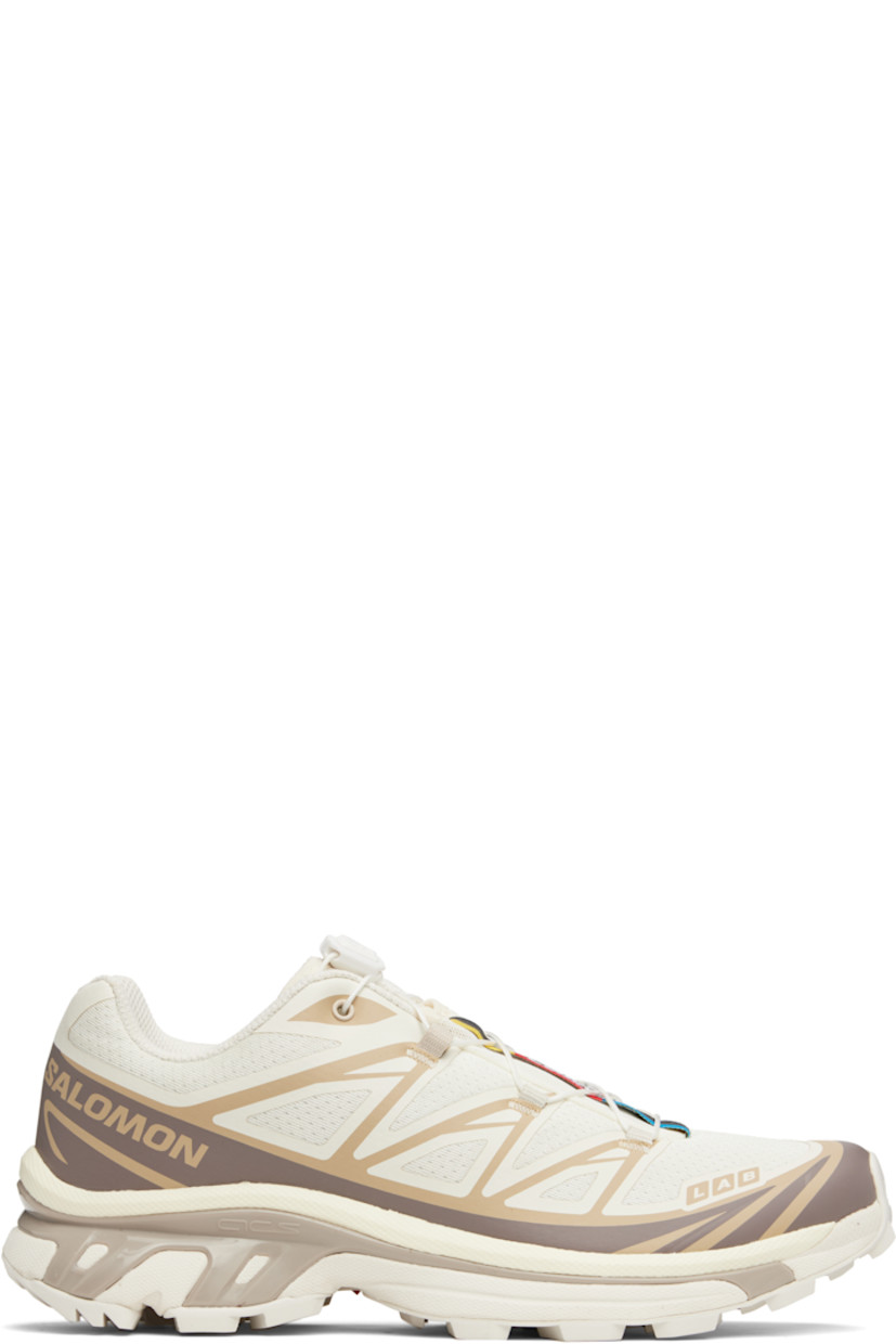 Low-top lightweight mesh sneakers in off-white and gray.

· Bonded trim throughout
· Logo embossed at toe
· Quicklace™ closure
· Logo patch at vamp
· Logo-woven pull-loop at padded tongue
· Padded collar
· Bonded sensiFIT™ panel at sides
· Logo printed at outer side
· Text printed at inner side
· Molded OrthoLite® insole
· EndoFit™ mesh lining
· Agile Chassis™ System at EnergyCell midsole
· Treaded Mud Contagrip® rubber sole

Supplier color: Vanilla ice/Iron/Etherea