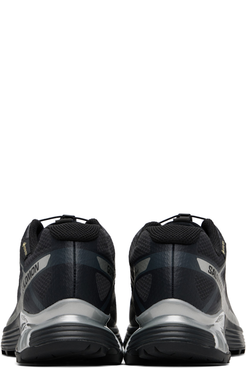 Low-top mesh sneakers.

· Waterproof GORE-TEX™ membrane
· Bonded trim throughout
· Quicklace™ closure
· Logo patch at vamp
· Logo-woven pull-loop at tongue
· Padded tongue and collar
· Logo printed at outer side
· Bonded SensiFit™ panel at sides
· Molded OrthoLite® insole
· Mesh lining
· Agile Chassis™ Skeleton at EnergyCell midsole
· Treaded Mud Contagrip® rubber sole

Supplier color: Black/Black/Ftw silver