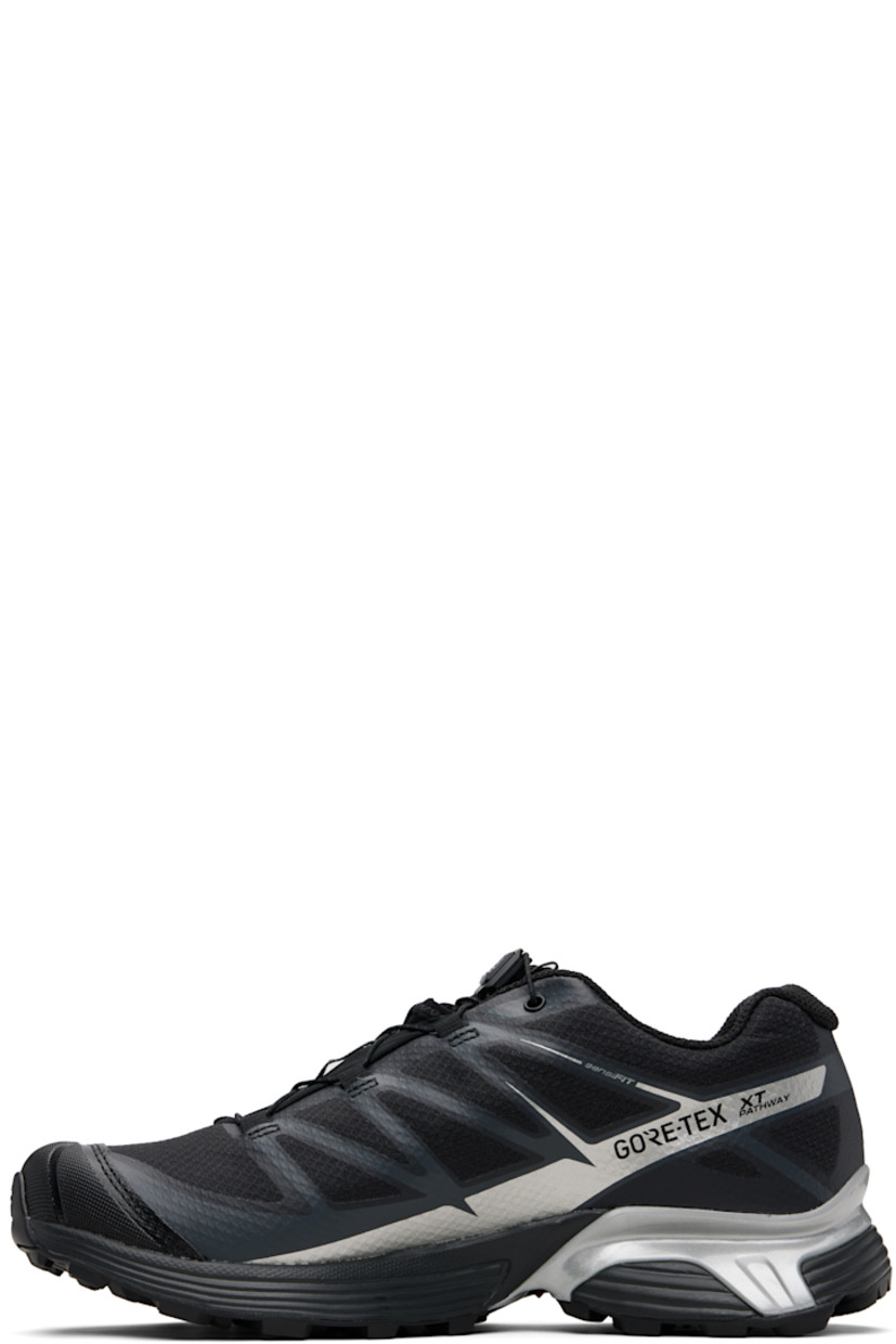 Low-top mesh sneakers.

· Waterproof GORE-TEX™ membrane
· Bonded trim throughout
· Quicklace™ closure
· Logo patch at vamp
· Logo-woven pull-loop at tongue
· Padded tongue and collar
· Logo printed at outer side
· Bonded SensiFit™ panel at sides
· Molded OrthoLite® insole
· Mesh lining
· Agile Chassis™ Skeleton at EnergyCell midsole
· Treaded Mud Contagrip® rubber sole

Supplier color: Black/Black/Ftw silver