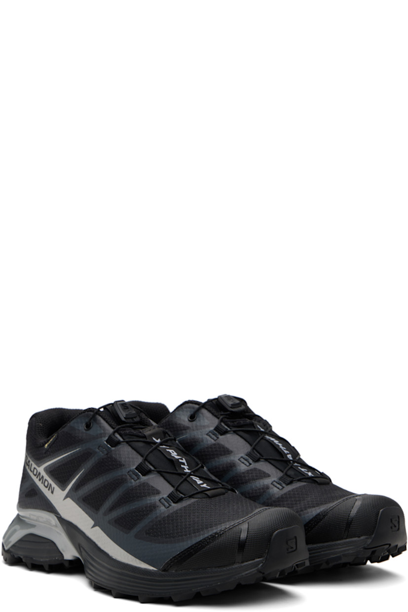Low-top mesh sneakers.

· Waterproof GORE-TEX™ membrane
· Bonded trim throughout
· Quicklace™ closure
· Logo patch at vamp
· Logo-woven pull-loop at tongue
· Padded tongue and collar
· Logo printed at outer side
· Bonded SensiFit™ panel at sides
· Molded OrthoLite® insole
· Mesh lining
· Agile Chassis™ Skeleton at EnergyCell midsole
· Treaded Mud Contagrip® rubber sole

Supplier color: Black/Black/Ftw silver