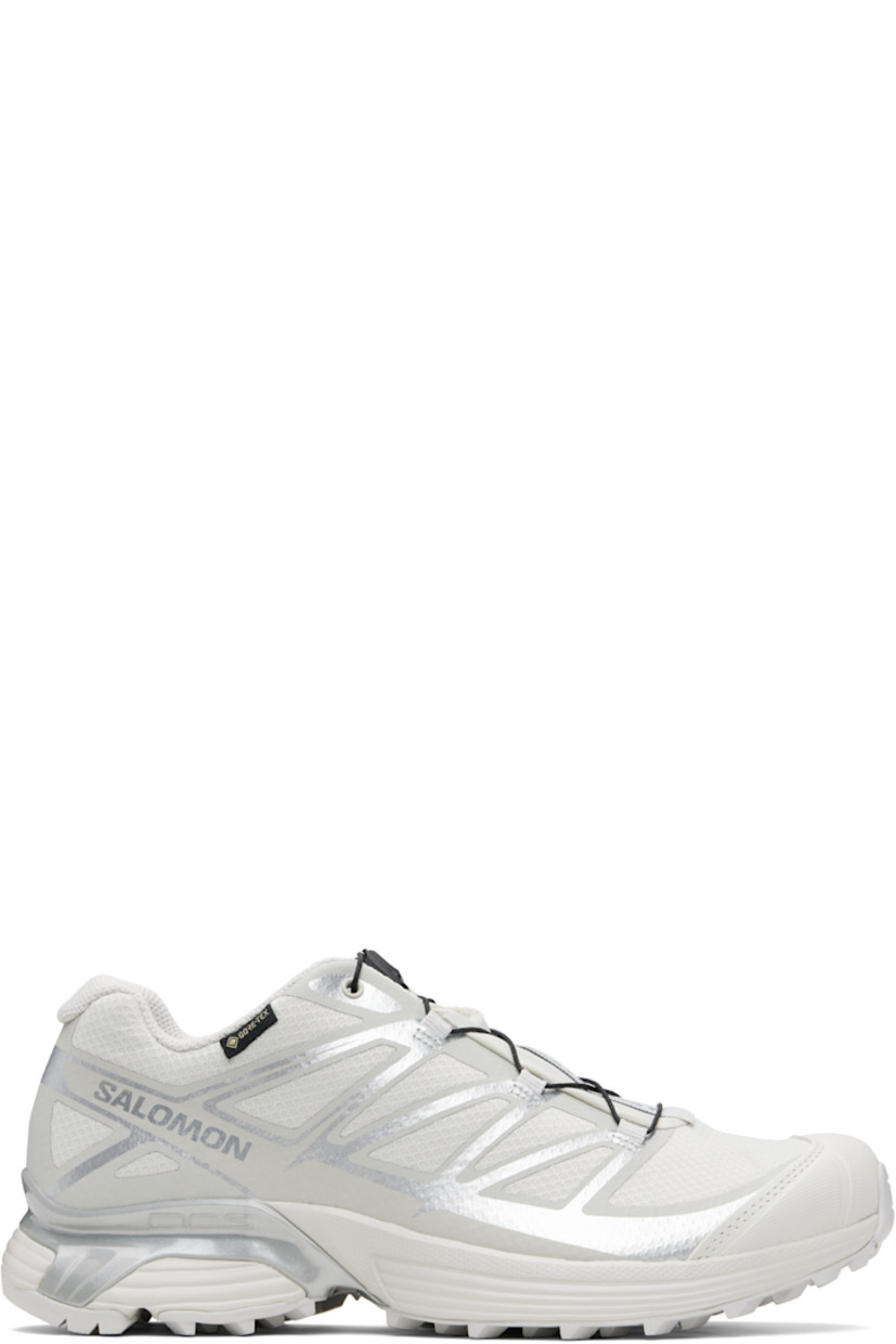 Low-top mesh sneakers.

· Waterproof GORE-TEX™ membrane
· Bonded trim throughout
· Quicklace™ closure
· Logo patch at vamp
· Logo-woven pull-loop at tongue
· Padded tongue and collar
· Logo printed at outer side
· Bonded SensiFit™ panel at sides
· Molded OrthoLite® insole
· Mesh lining
· Agile Chassis™ Skeleton at EnergyCell midsole
· Treaded Mud Contagrip® rubber sole

Supplier color: Lunar rock/Alloy/Ftw silver