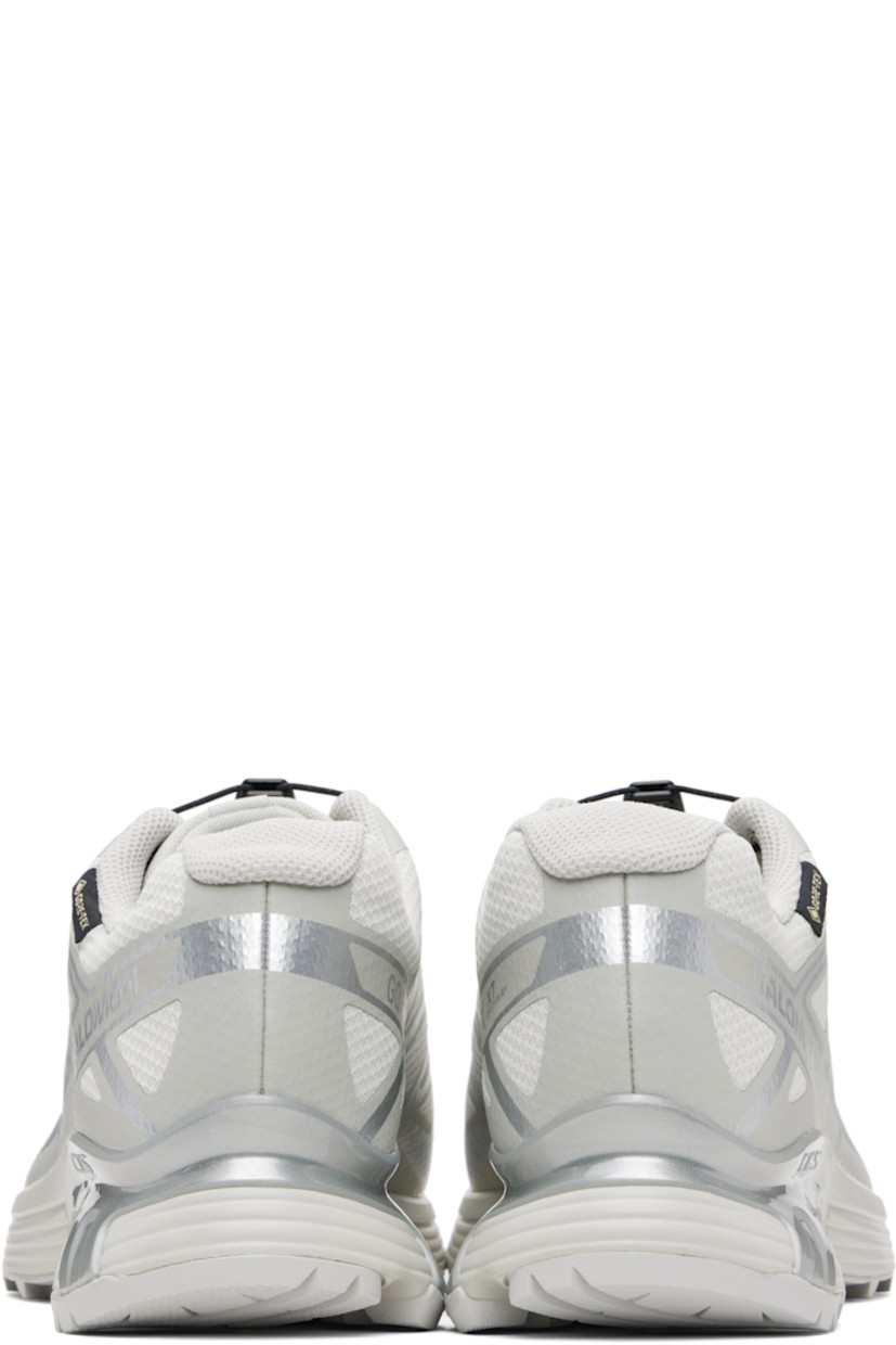 Low-top mesh sneakers.

· Waterproof GORE-TEX™ membrane
· Bonded trim throughout
· Quicklace™ closure
· Logo patch at vamp
· Logo-woven pull-loop at tongue
· Padded tongue and collar
· Logo printed at outer side
· Bonded SensiFit™ panel at sides
· Molded OrthoLite® insole
· Mesh lining
· Agile Chassis™ Skeleton at EnergyCell midsole
· Treaded Mud Contagrip® rubber sole

Supplier color: Lunar rock/Alloy/Ftw silver