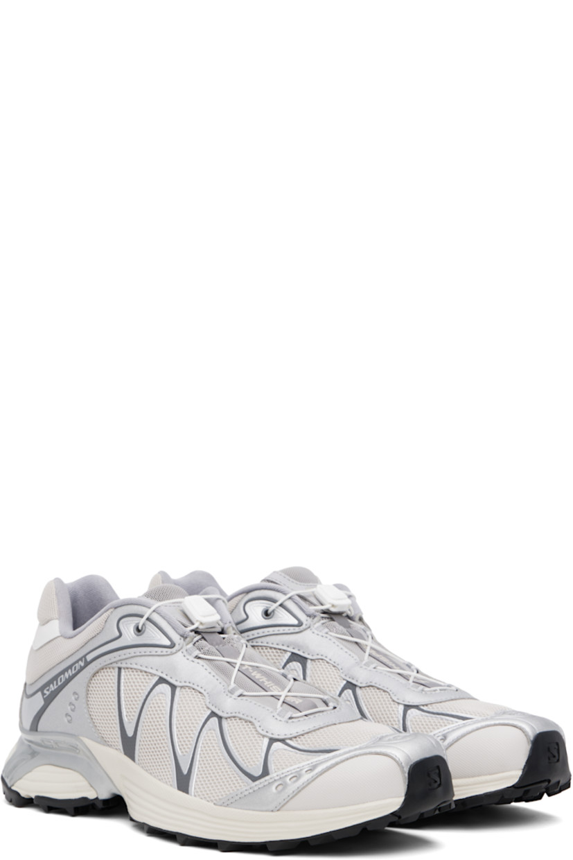 Low-top mesh and faux-leather sneakers in silver tone and beige.

· Reflective detailing throughout
· Logo embossed at toe
· Quicklace™ closure
· Logo patch at padded tongue
· Padded collar
· sensiFIT™ panel at sides
· Logo printed at outer side and heel tab
· Molded OrthoLite® insole
· Mesh lining
· Agile Chassis™ System at rubber EnergyCell midsole
· Treaded Mud Contagrip® rubber sole

Supplier color: Ftw silver/Lunar rock/Silver cloud