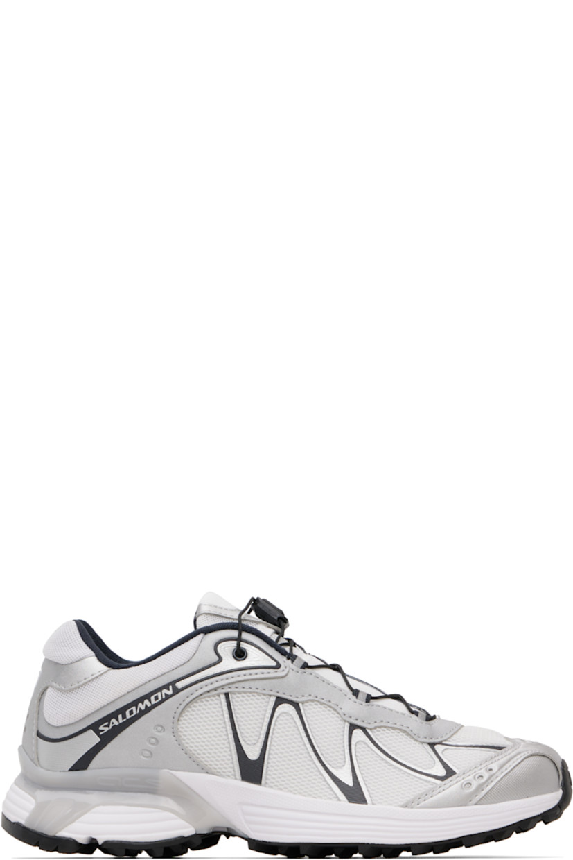 Low-top anti-debris 3D mesh and faux-leather sneakers.

· Reflective trim throughout
· Perforations and embossed logo at toe
· Quicklace™ closure
· Logo patch at padded tongue
· Padded collar
· Bonded sensiFIT™ panel at sides
· Logo printed at outer side and heel tab
· Molded OrthoLite® footbed
· Mesh lining
· Agile Chassis™ System at foam rubber EnergyCell midsole
· Treaded Mud Contagrip® rubber sole

Supplier color: White/Ftw silver/Dark navy
